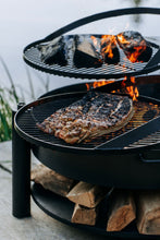 Lade das Bild in den Galerie-Viewer, Multifunktionale Feuerschale „MONTANA X“ 60 cm mit Grillrost 50 cm - Cook King - Shop
